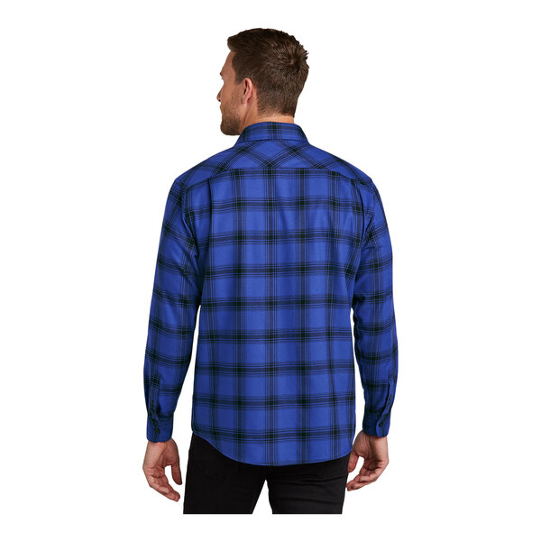 A man wearing a Port Authority blue plaid flannel shirt.