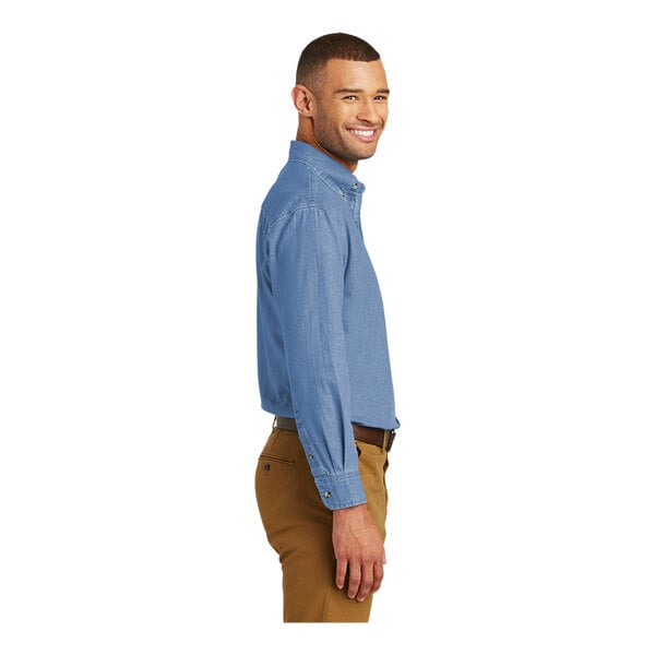 A man wearing a faded blue Port & Company short sleeve denim button-down shirt.