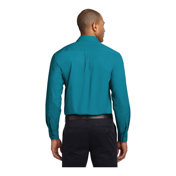 A man wearing a Port Authority teal green dress shirt.