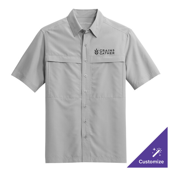 A Port Authority grey short sleeve shirt with a logo on the chest.