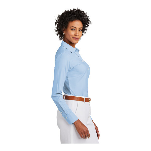 A woman wearing a blue Brooks Brothers Newport dress shirt.