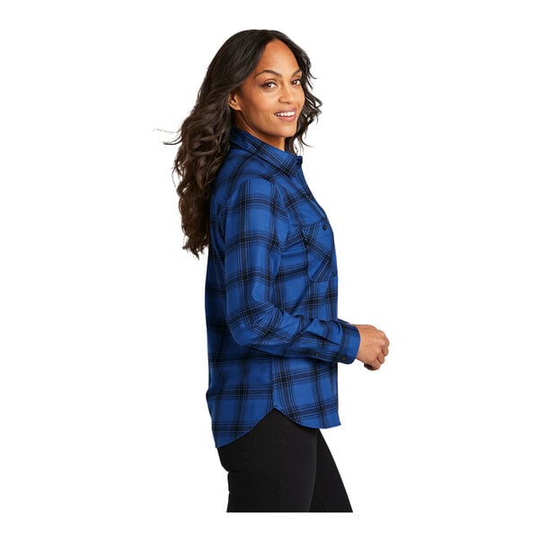 A woman wearing a royal blue and black plaid flannel shirt.