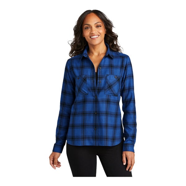 A woman wearing a royal blue and black plaid Port Authority flannel shirt.