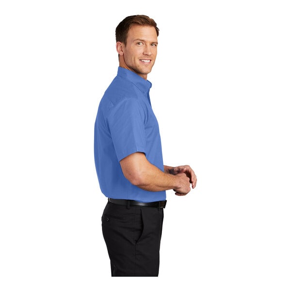 A man wearing a Port Authority ultramarine blue short sleeve dress shirt.