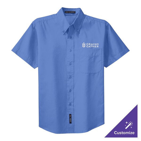 A blue Port Authority short sleeve dress shirt with a logo on the chest.