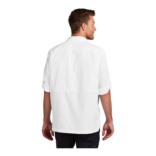 A man wearing a Port Authority white long sleeve shirt.