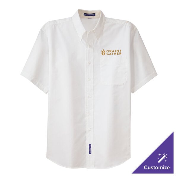 A white Port Authority dress shirt with gold embroidery on the chest.