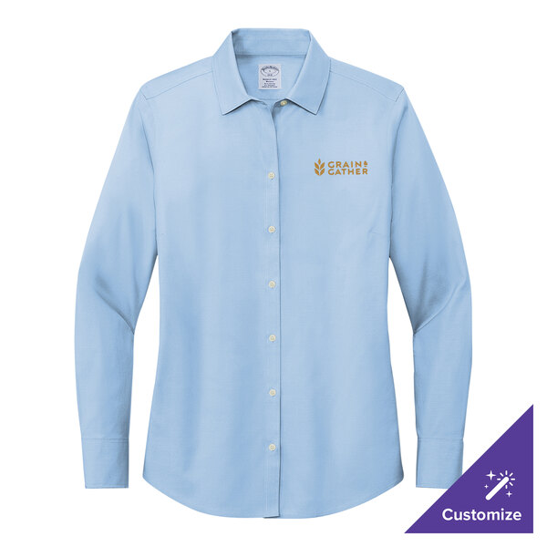 A Brooks Brothers long sleeve light blue dress shirt for women.