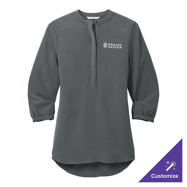 A graphite Port Authority women's tunic blouse with the word, "empower" on it.