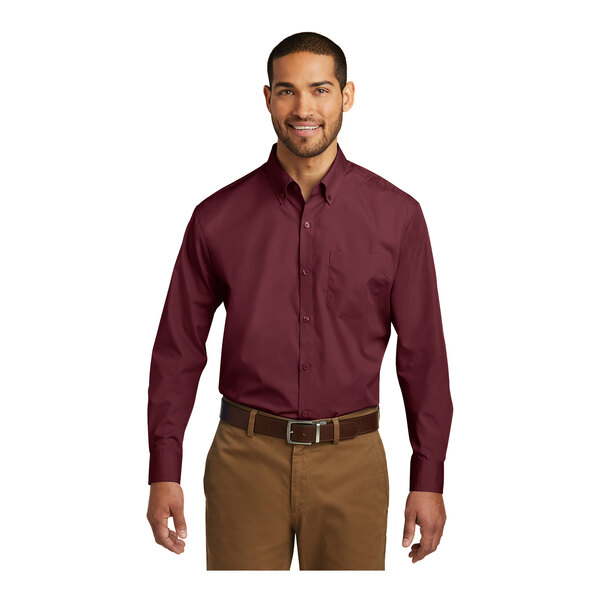 A man wearing a Port Authority burgundy long sleeve poplin shirt.