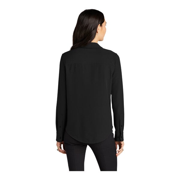 A woman wearing a Mercer+Mettle black long sleeve camp blouse with the back untied.