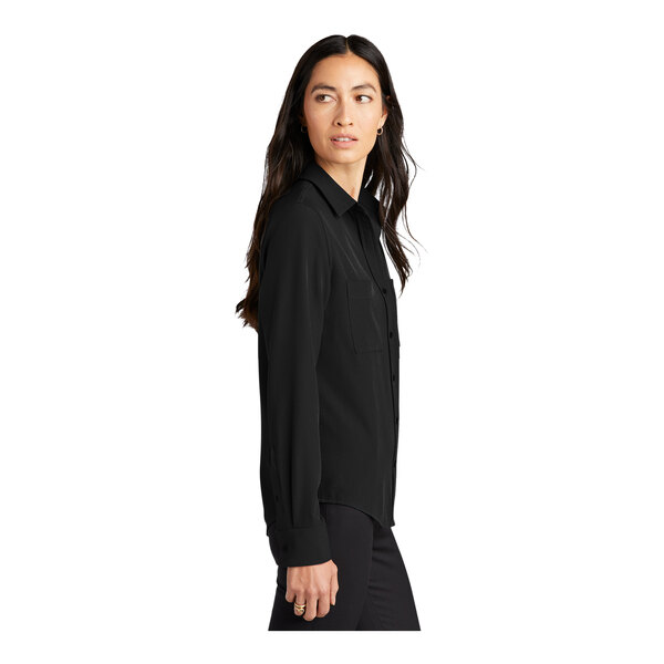 A woman wearing a Mercer+Mettle black long sleeve camp blouse.