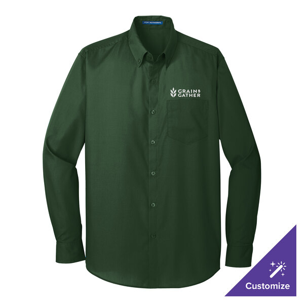 A long sleeved deep forest green Port Authority dress shirt on a counter with white text.