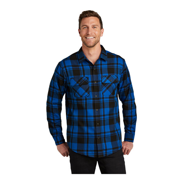 A man wearing a Port Authority blue and black plaid flannel shirt.