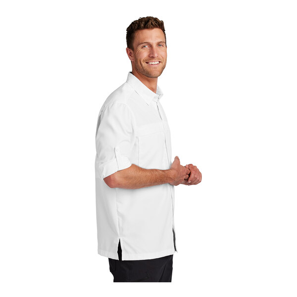 A man wearing a white Port Authority long sleeve shirt.