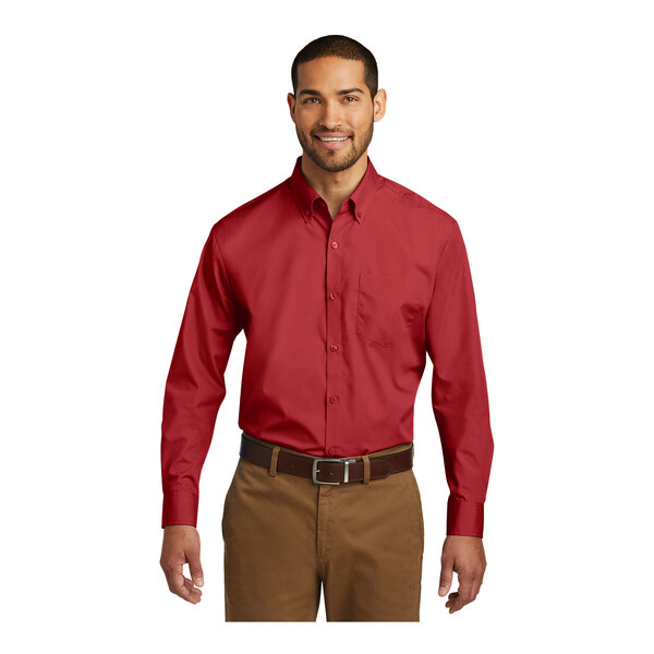 A man wearing a Port Authority long sleeve red poplin dress shirt.