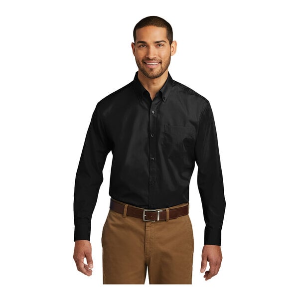 A man wearing a black Port Authority long sleeve poplin shirt.