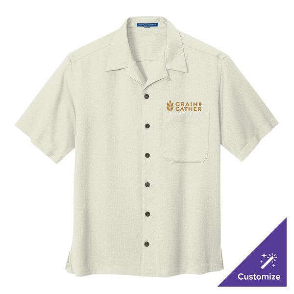 A white Port Authority camp shirt with gold logo embroidery.