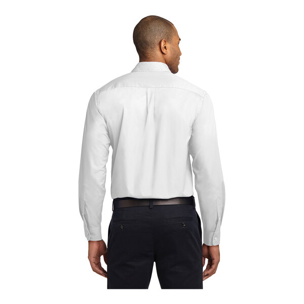 A man wearing a white Port Authority dress shirt.