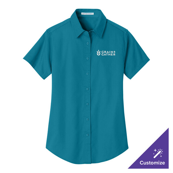 A teal Port Authority women's dress shirt with white logo on the front.