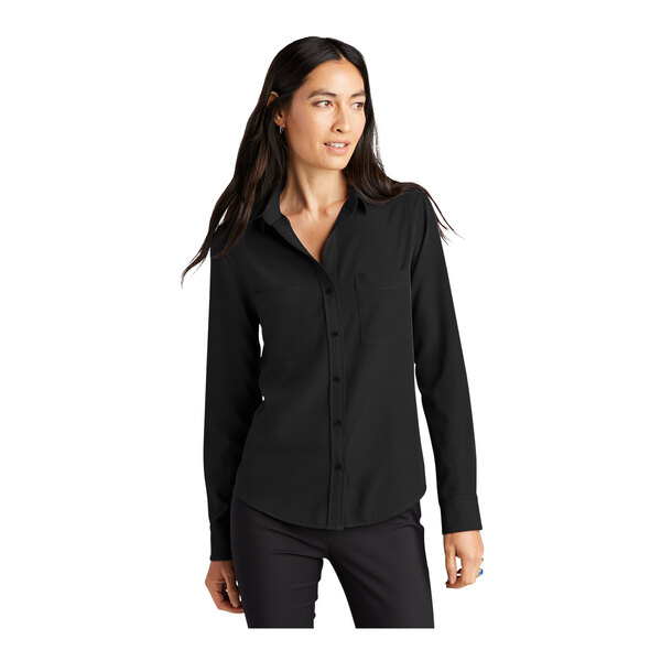 A woman wearing a Mercer+Mettle long sleeve black camp blouse.