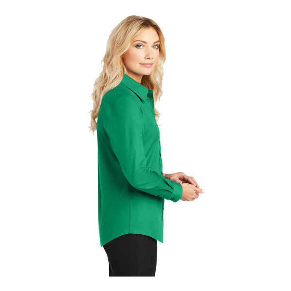 A woman wearing a Port Authority Court Green long sleeve dress shirt.