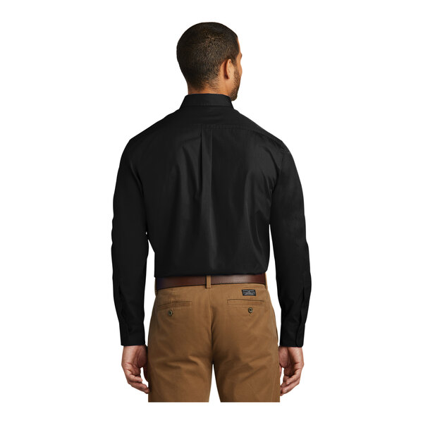A man wearing a Port Authority black long sleeve poplin dress shirt.