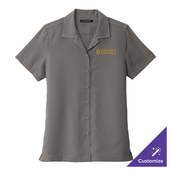 A women's grey Port Authority staff shirt with gold embroidery.