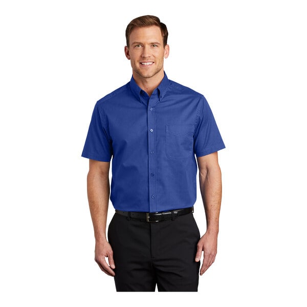 A man wearing a Port Authority short sleeve dress shirt in royal blue and classic navy.