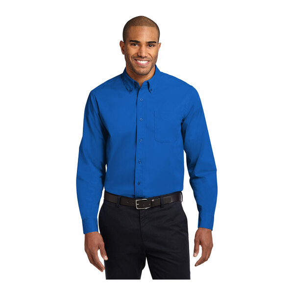 A man wearing a Port Authority strong blue long sleeve poplin shirt.