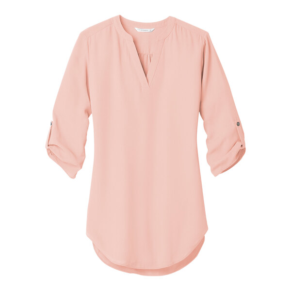 A rose quartz Port Authority blouse with rolled short sleeves and a v-neck.
