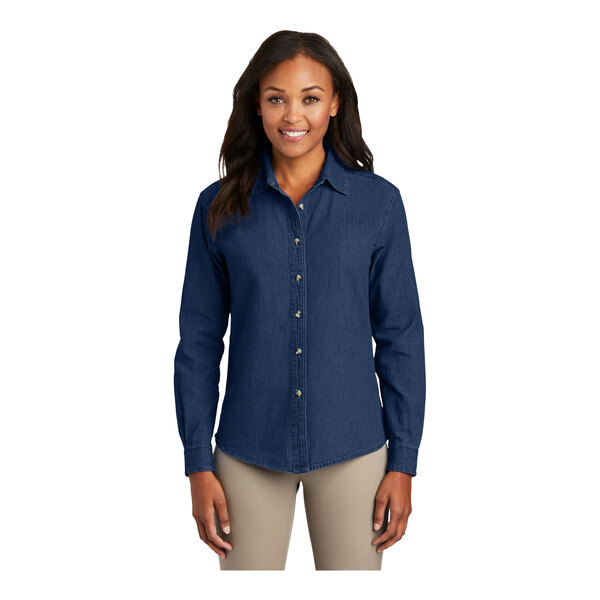 A woman wearing a Port & Company short sleeve denim button-down shirt in ink blue.