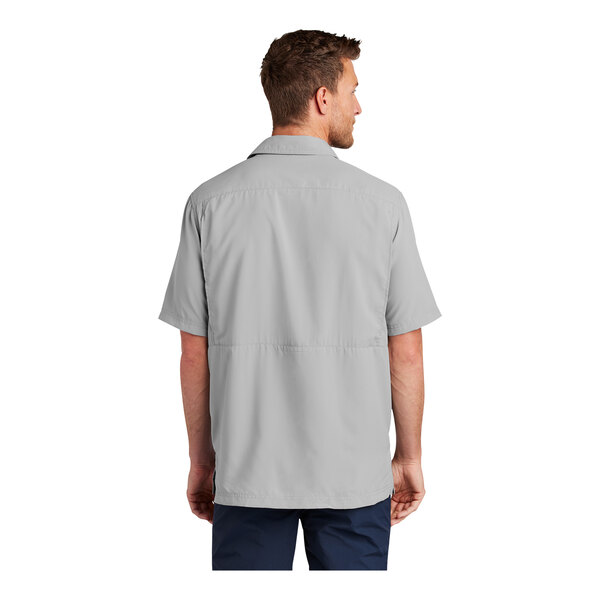 A man wearing a Port Authority Gusty Gray short sleeve shirt.