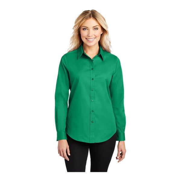 A woman wearing a Port Authority Court Green long sleeve dress shirt.