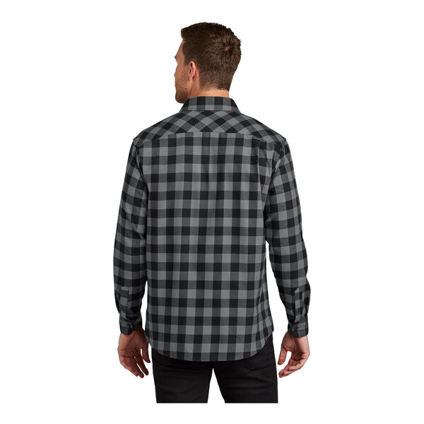 A man wearing a black and grey Port Authority buffalo check flannel shirt.