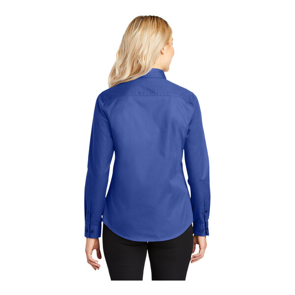 A woman wearing a Port Authority long sleeve royal blue dress shirt.