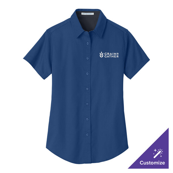 A blue Port Authority short sleeve dress shirt with a white logo on the chest.