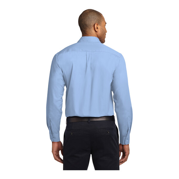 A man wearing a light blue Port Authority dress shirt.