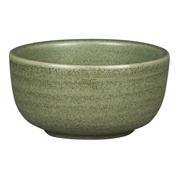 A close-up of a dark green Rakstone Selva porcelain ramekin with speckled texture.