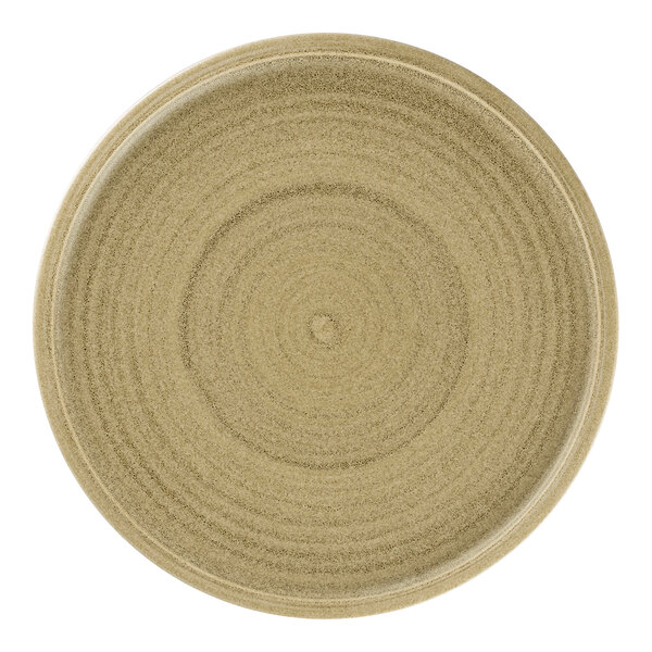 A close-up of a Rak Porcelain beige flat coupe plate with a circular pattern.