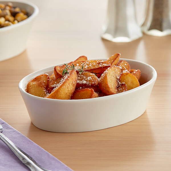 An Acopa ivory stoneware bowl filled with food.