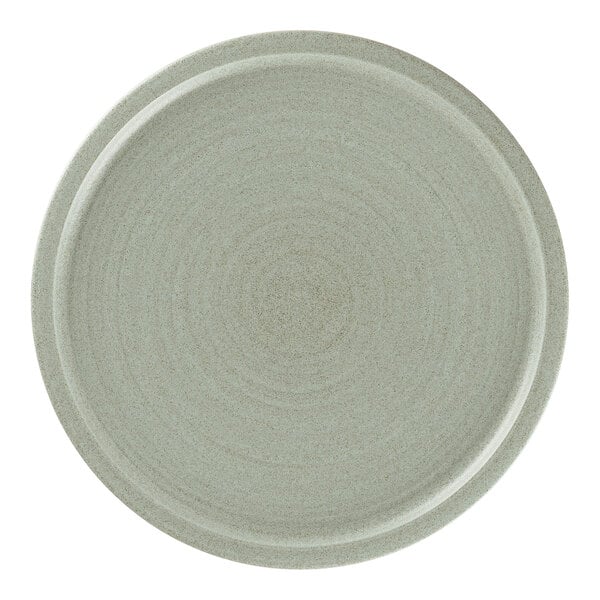 A Rak Porcelain aqua green flat coupe plate with a white rim.