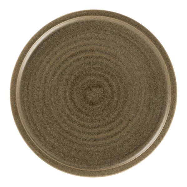 A close-up of a dark brown Rak Porcelain flat coupe plate with a spiral design.