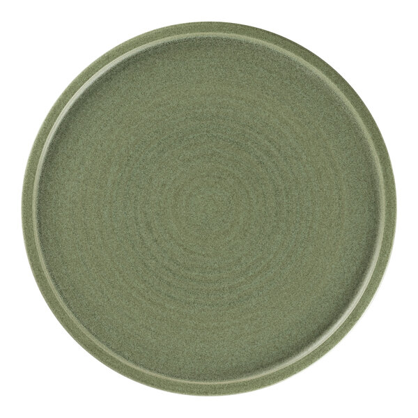 A dark green Rakstone Selva porcelain coupe plate with a circular rim.