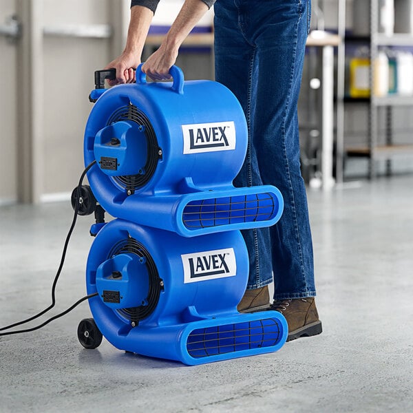 A man holding a blue Lavex air mover.