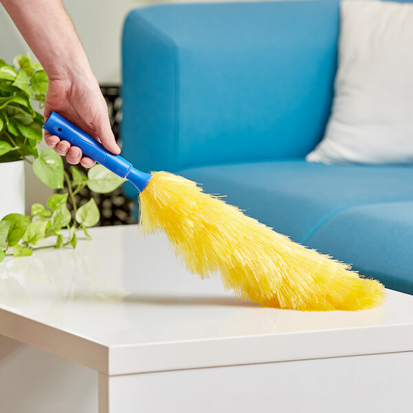 A hand holding a yellow and blue Ettore polyester duster.