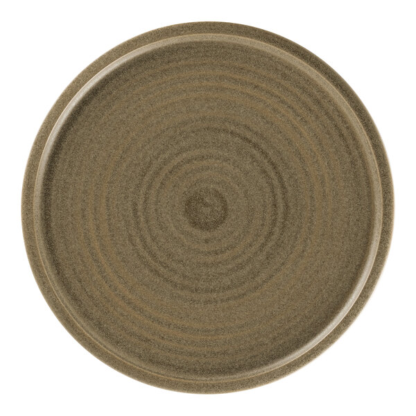 A close-up of a dark brown Rak Porcelain flat coupe plate with a spiral design.