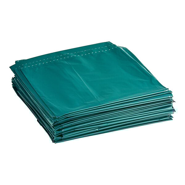 A stack of green Trinity Plastics low-density trash bags.