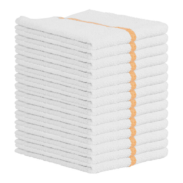 A stack of white Monarch Brands bar towels with gold stripes.