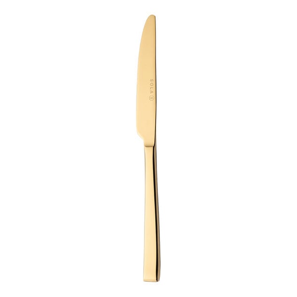 A close up of a Sola the Netherlands Durban Gold stainless steel dessert knife with a gold handle.